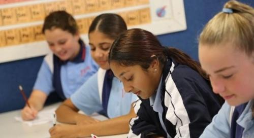 Students writing on paper